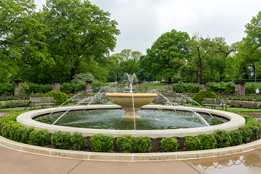 May 16, 2021 - Kansas City, Missouri, USA: This shot shows one of the many fountains found in Kansas City, Missouri.  The city is known for its fountains and this one is located in Loose Park in southern Kansas City.  This was the site of the city's first Country Club.  This shot was taken on a rainy, overcast spring day.