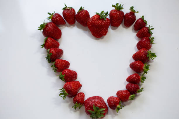 istock strawberries heart on white background 1320992132