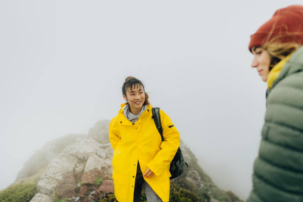 istock Friends on the mountain peak 1320992848