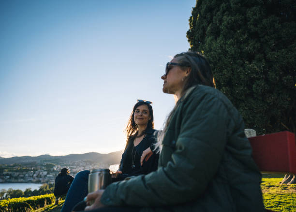 istock Friends relax on bench, at viewpoint over lake Lugano 1320992903