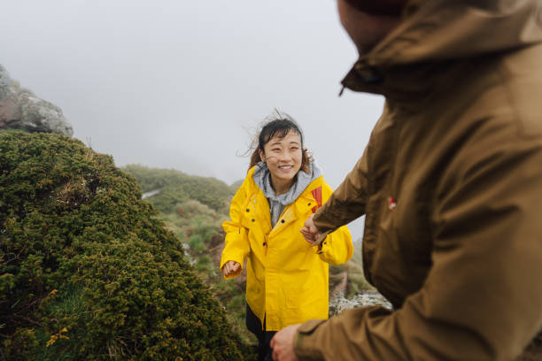 istock Couple on the foggy mountain 1320993084