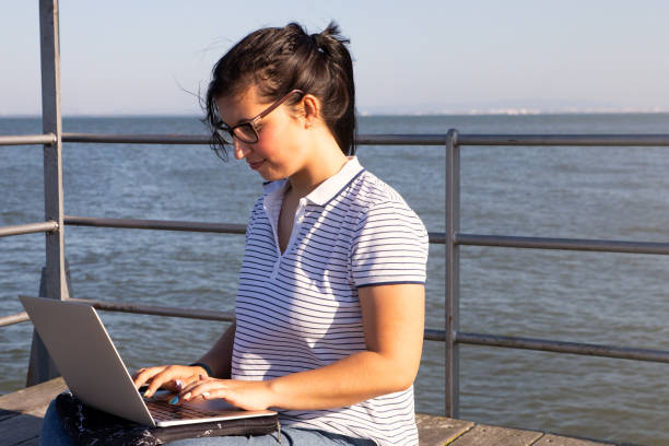 istock Young female working near the river 1320994379