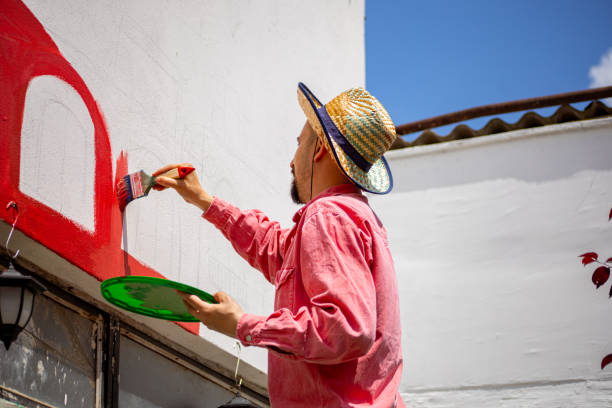 istock Artist painting wall mural 1320994675