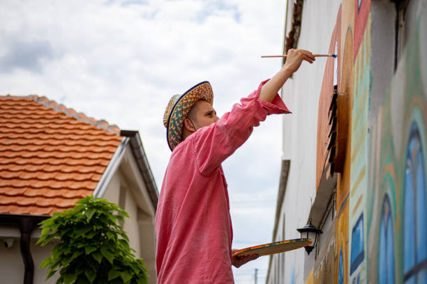 istock Artist painting details on a mural 1320995265