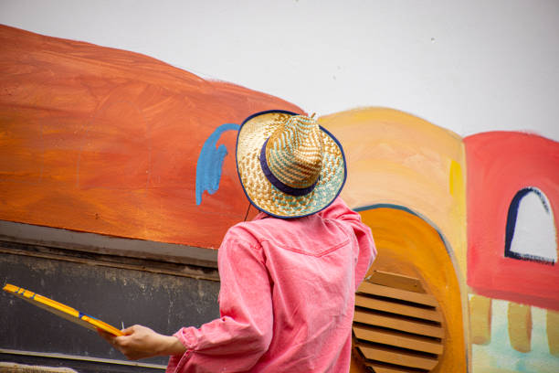 istock Artist painting details on a mural 1320995272