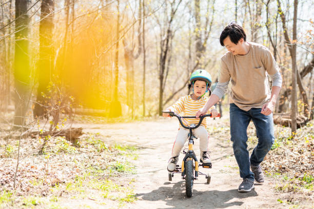 istock Happy toddler on a bike with dad support 1320995651