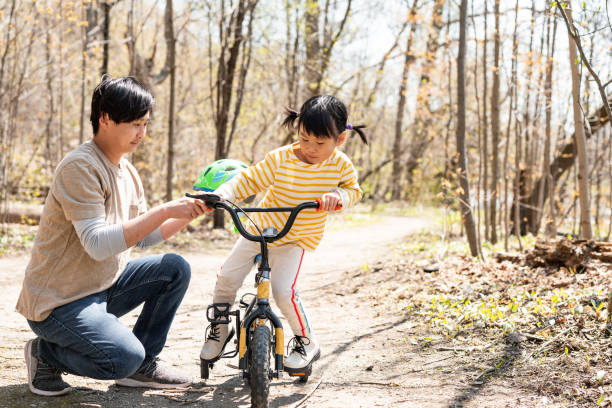istock Father and daughter on a bike walk 1320995657