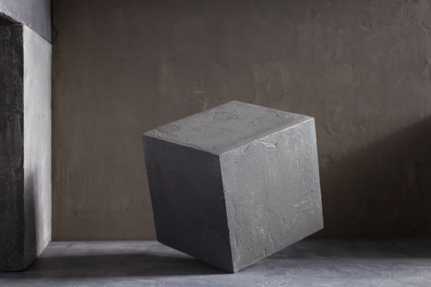 istock Concrete cube or construction brick near wall background texture. Abstract art or construction concept 1320996665