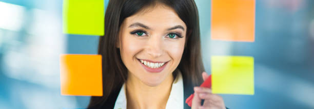 istock The smile woman writing a note on the sticker 1320998139