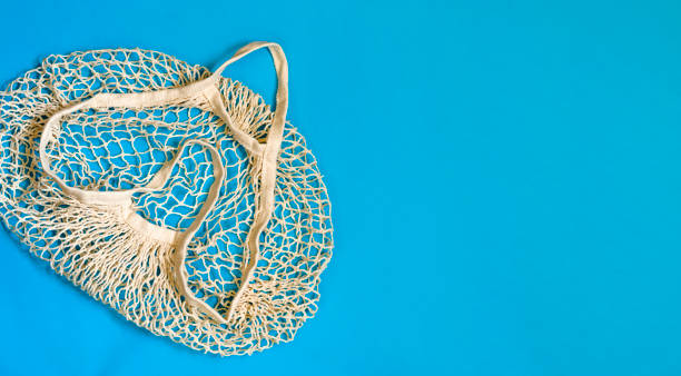 istock Empty reusable eco shopping bag on a blue background. String bag for delivery. Zero waste concept. Top view. Copy space. 1320999261