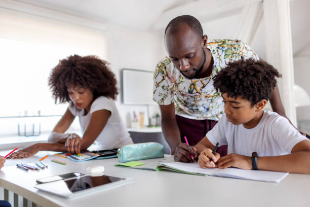 istock Father Helping His Son With His Homework 1320999387