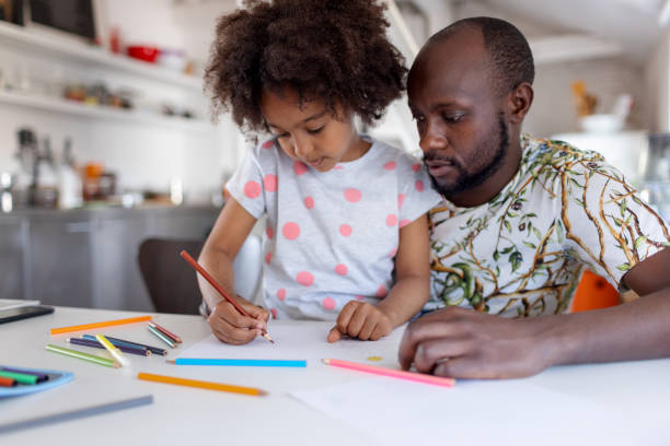 istock Caring Dad Coloring With His Daughter 1320999416