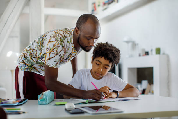 istock Father Helping His Son With His Homework 1320999428