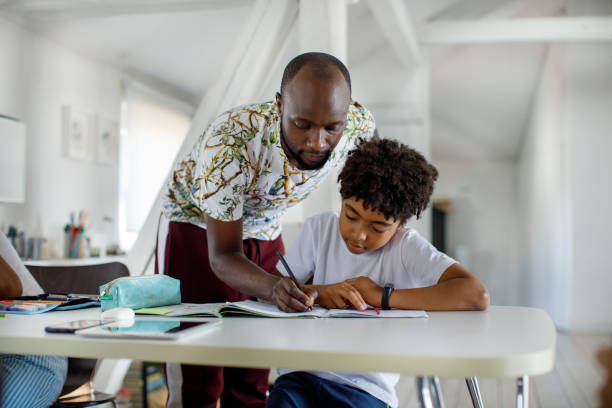 istock Father Helping His Son With His Homework 1320999443