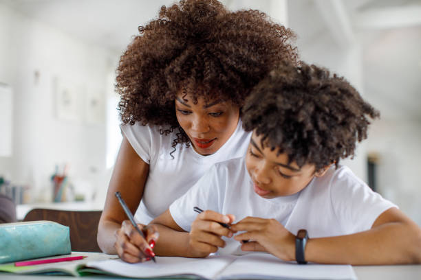 istock Mother Helping Her Son With His Homework 1320999447