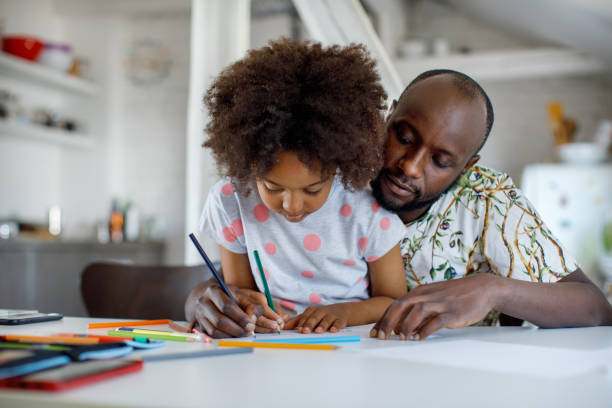istock Father And Daughter Coloring Together 1320999464