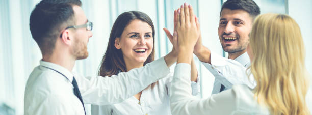 istock The four business people greeting with a high five 1321000949