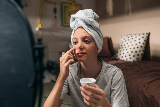 istock girl at home applying cosmetic face mask 1321001117