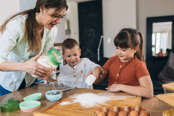 istock mother and kids baking together 1321001187