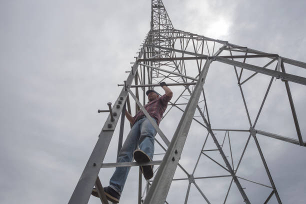 istock Building new electricity pylon. Worker is climbing up on pylon 1321001216