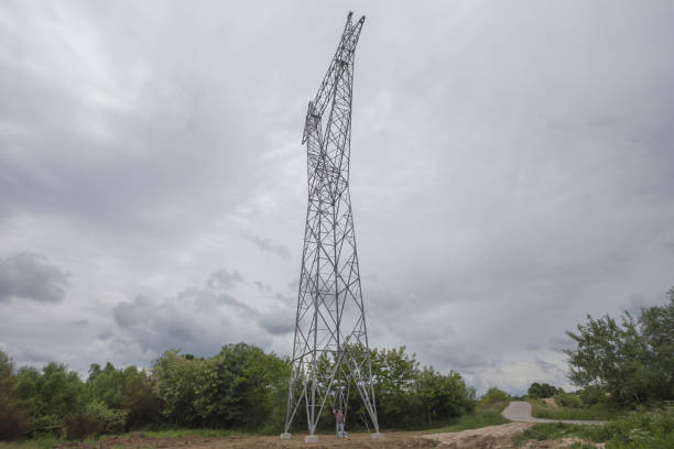 istock Building new electricity pylon. Worker is standing at the bottom pylon 1321001248