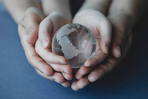 istock Mother And Her Daughter Are Holding A Glass Globe 1321001320