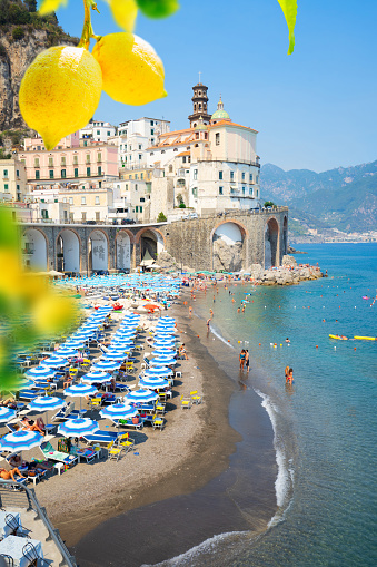 Amalfi old town and summer Atrani beach with umbrellas , Italy