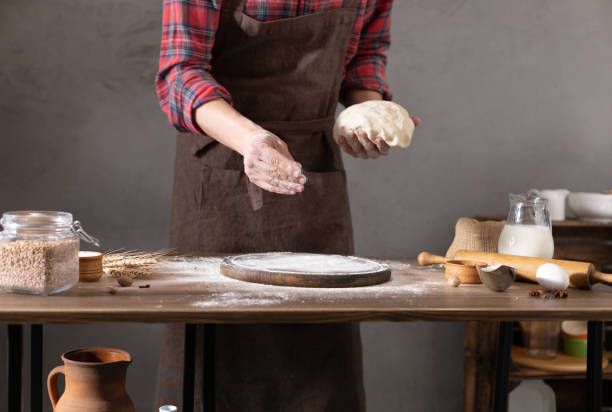 istock Chef man making dough and bakery ingredients for homemade bread cooking on table. Bakery concept with male hand 1321001668