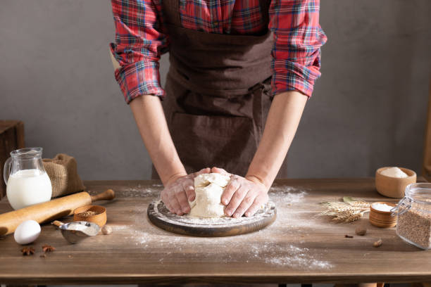 istock Chef man making dough and bakery ingredients for homemade bread cooking on table. Bakery concept with male hand 1321001734