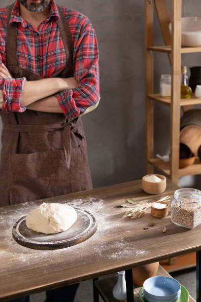 istock Chef man making dough and bakery ingredients for homemade bread cooking on table. Bakery concept with male hand 1321001746