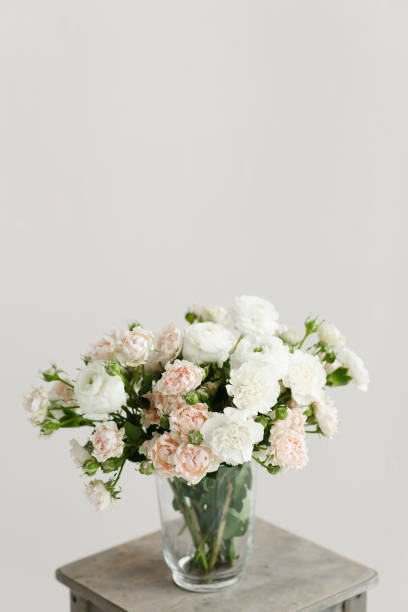 istock bouquet of flowers in a vase on a wooden table on a white solid background 1321002499