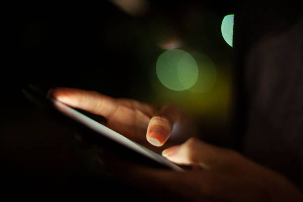 istock Close up of woman´s hand using touchscreen device at night 1321005007