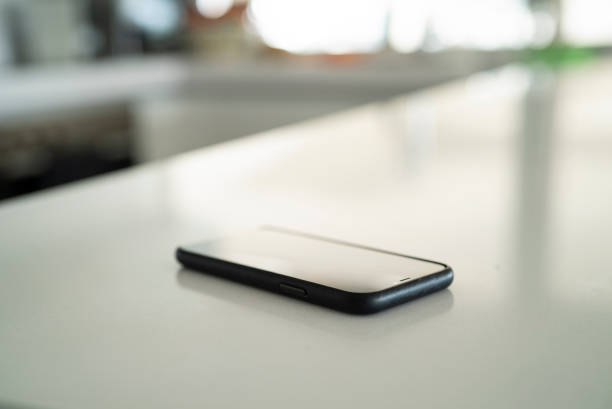 istock Close up of smart phone on kitchen counter during daytime 1321005040