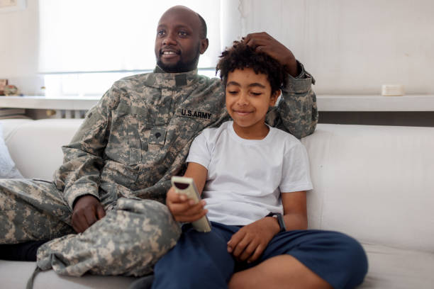 istock Army Father And Son Watching TV Together 1321005713