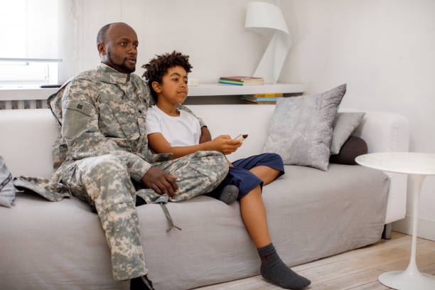 istock Army Father And Son Watching TV Together 1321005826