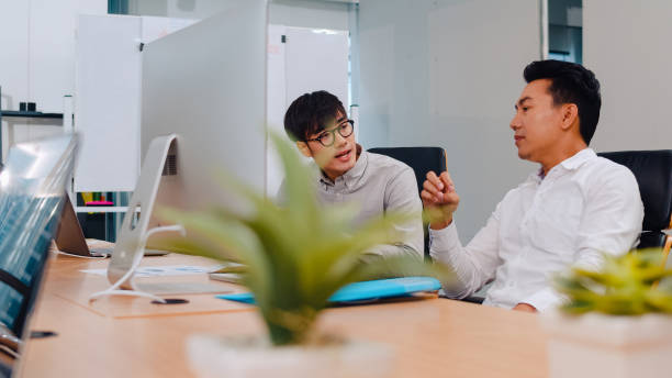 istock Businesspeople chatting to intern discussing job interview colleagues having conversation and communication meeting brainstorming ideas about project working plan success strategy in office. 1321007550