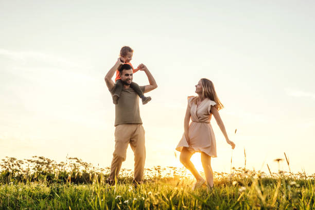 istock Happy family playing on sky sunset background. 1321008212