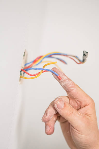 istock Electrician, monitors the wires in the sockets. Close up with tools 1321009016