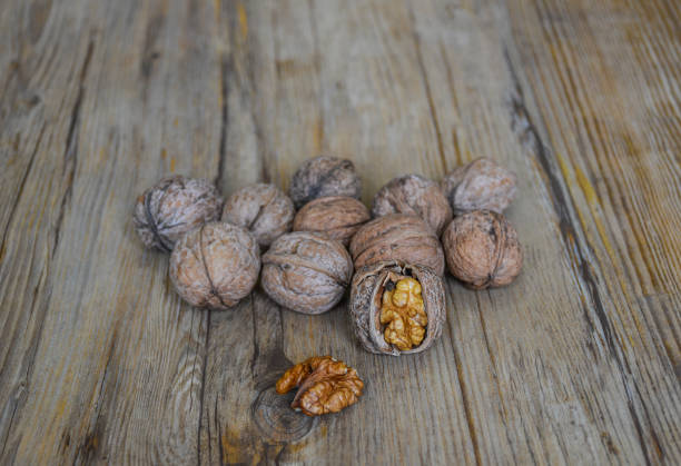 istock Walnuts closeup on a wooden background, selective focus 1321009515