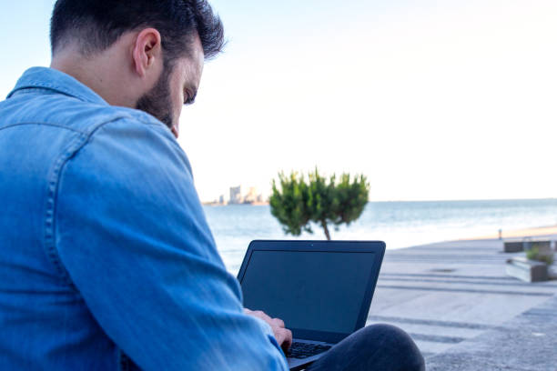 istock Man working on a computer in the outdoors 1321009552