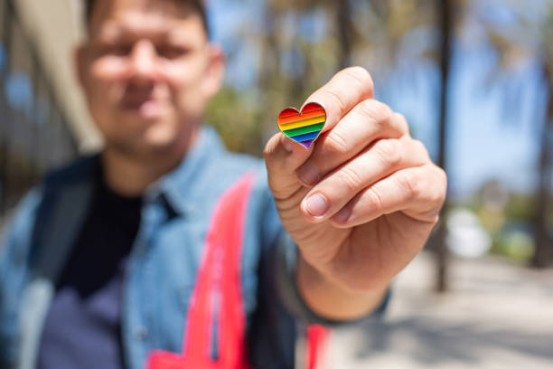 istock Man with rainbow reusable bag and lgbt badge, pride month 1321010467