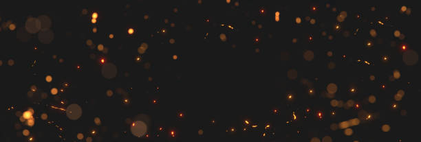 istock blurred yellow and golden glow sparks from neon lights with blank spot on black backgound 1321010681