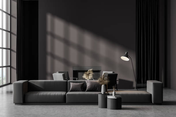 istock Contemporary dark grey living room interior with fireplace, sofa and armchairs. Wall copy space. Panoramic window. 1321010928