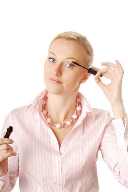 istock Blonde woman applying mascara with a wand 1321011141