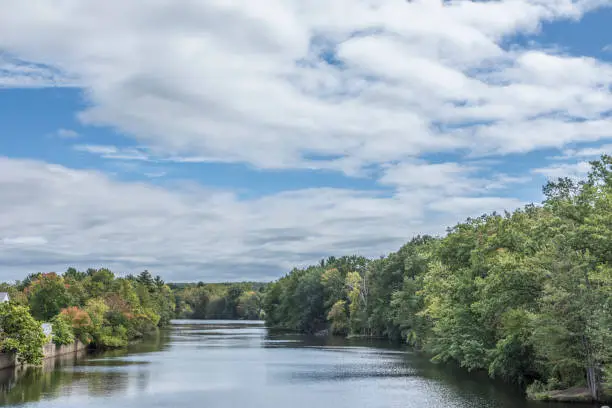 James River at Wilbraham, USA with trees and soft cloudy blue sky