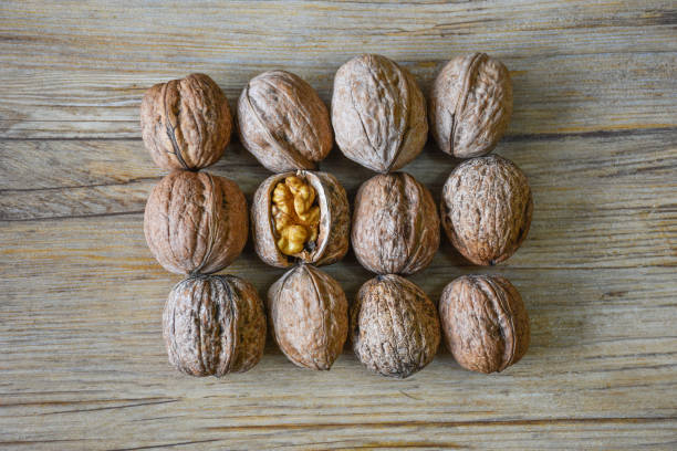 istock Walnuts closeup on a wooden background, selective focus 1321012647