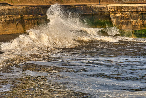 istock Waves crashing against concrete coastal wall, Cromer, Norfolk, England, Britain 1321013621