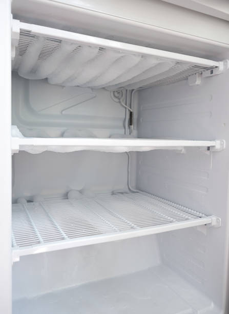 broken fridge. snow on freezer shelves. defrosting the fridge broken fridge. snow on freezer shelves. defrosting the fridge. fridge frosting stock pictures, royalty-free photos & images
