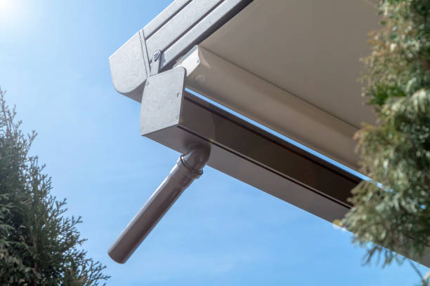istock canvas awning with metal frame and drainage pipe against blue sunny sky. modern shading for house 1321015259