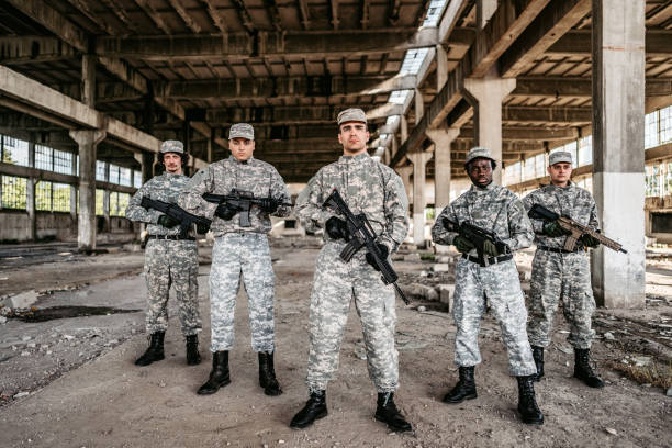 Soldier squad team portrait in urban environment wearing camouflage clothes and holding weapons.